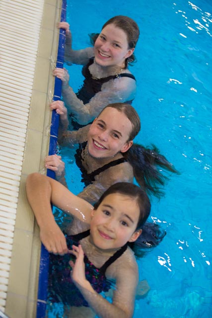 three teenagers smiling in swimming pool