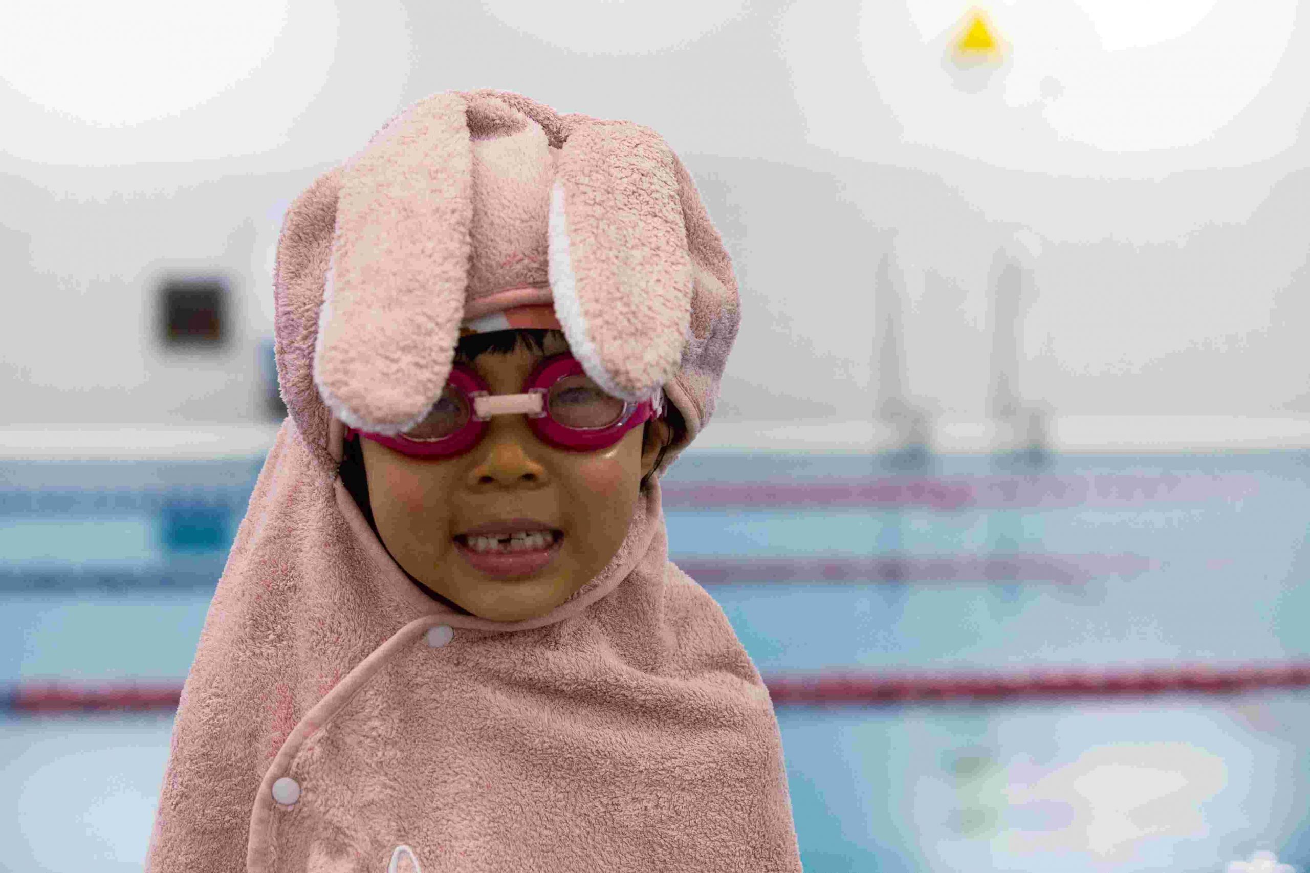 Toddler in hooded towel and goggles