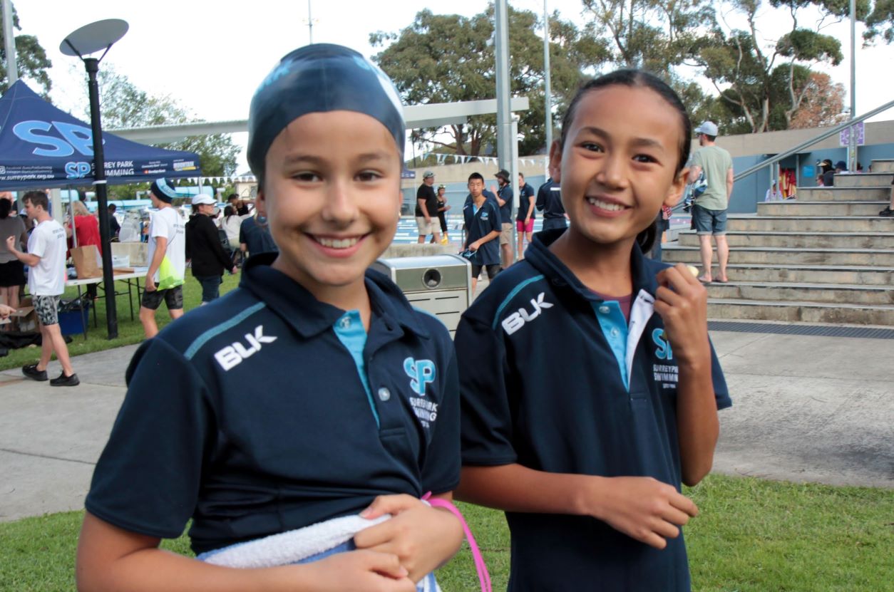 Two young female Surrey Park Swimmers smiling