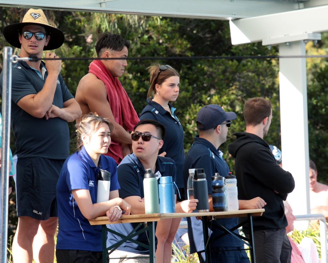 Our coaches watching the swimming pool at Club Championships